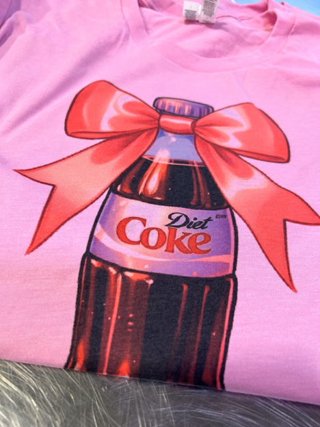 Pink Bow Diet Coke bottle valentine bow soda Graphic Tee: Peach / S
